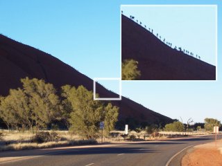 People climbing Uluru.